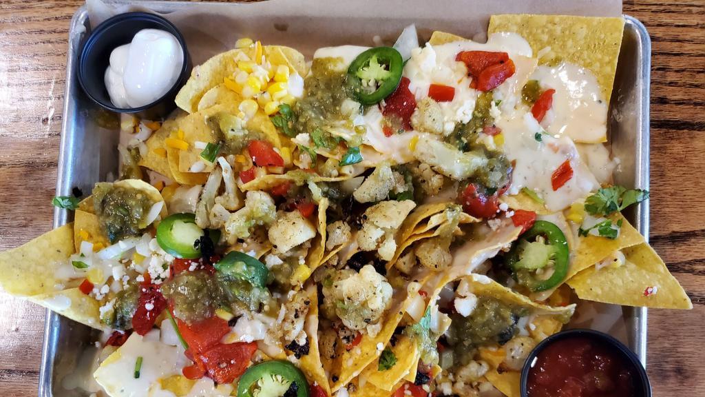 Veggie Verde Nachos · White queso, cheddar jack & Cotija cheeses, fire-roasted red peppers, fresh jalapeños, sour cream, salsa, onion & cilantro (1455 CAL.).