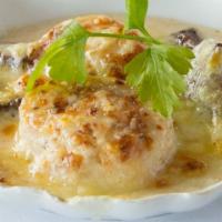 St Jacques Au Gratin · Diver sea scallops, button mushrooms, bechamel, Swiss cheese.