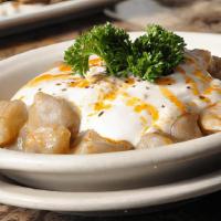 Manti Meze · Handmade dumplings filled with beef and topped with cool yogurt sauce and garlic butter.