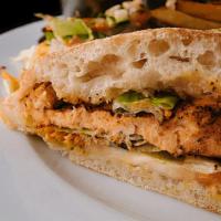 Salmon Club Sandwich · Grilled salmon, lettuce, and tomato on a baked roll.