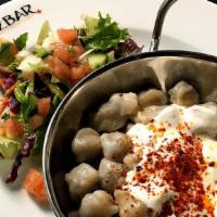 Manti · Turkish beef dumplings topped with yogurt and garlic butter. Served with salad.