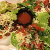 Gringo Tacos · Three soft flour tortilla tacos with choice of meat, lettuce, cheese, and pico de gallo with...