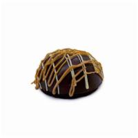 Chocolate Bombe · A moist devil’s food cake base with a house-made chocolate ganache dome filled with a carame...
