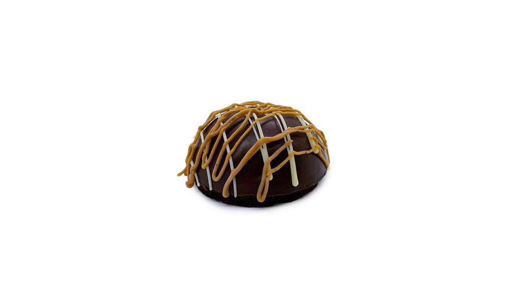 Chocolate Bombe · A moist devil’s food cake base with a house-made chocolate ganache dome filled with a caramel mousse core mixed with mini caramel microchips.