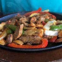 Mixed Fajita · Beef, chicken, and shrimp, onions, tomatoes, green peppers, cheese. Served with rice, beans,...