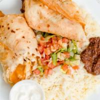 Chimichanga · Fried flour tortillas with beef, chicken, and vegetables. Served with rice, beans, cream, an...