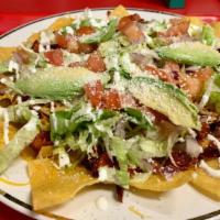 Nachos · Our delicious homemade nacho chips, topped with refried beans the meat of your choice, and s...