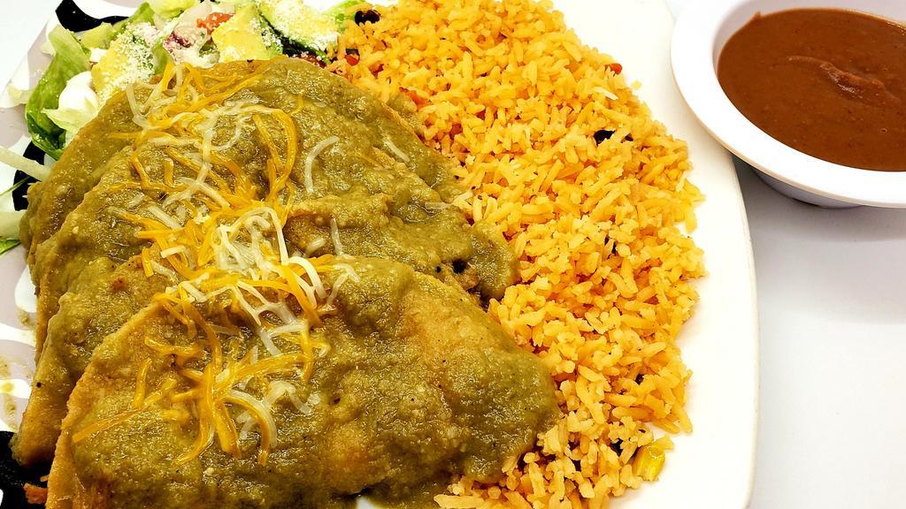 Enchilada · Four corn tortillas filled with chicken dipped in sauce, (green or red sauce) served with rice beans and salad on the side.