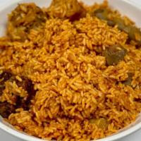 Flavorsome Nigerian Jollof Rice · A small Bowl of Jollof rice. A spiced dish, simmered in reduced tomatoes, onions, peppers. A...