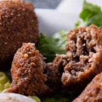 Kibbeh · Deep fried bulgur balls with ground beef, onions, pine nuts, and our special spices. Served ...