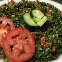 Tabouli Salad · A traditional Lebanese mediterranean salad made with fresh parsley, green onions tomatoes, a...