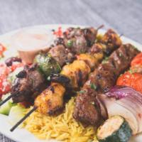 Combo Kebab Combination · Lamb, chicken, kafta and veggie kebabs served with a bed of basmati rice and Greek salad.