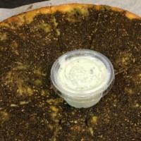 Zaatar Pizza · One of our original creations, a fragrant combination of thyme, sesame, sumac and olive oil.