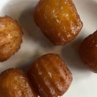 Awama · Mini doughnut balls covered with honey syrup.