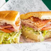 Classic Club · Turkey, ham, bacon, cheddar, swiss, lettuce, tomato, pickles, pepperoncini, and mayonnaise.