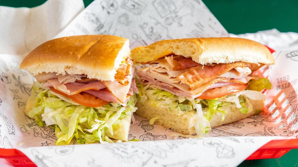 Classic Club · Turkey, ham, bacon, cheddar, swiss, lettuce, tomato, pickles, pepperoncini, and mayonnaise.