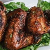 Jerk Wings · Wings marinated in spicy jerk sauce. comes with sides of coconut rice and beans plantains st...
