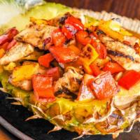 Fajita Tropical · Grilled pineapple filled with chicken or steak, sautéed peppers, onions, and tomatoes. Serve...