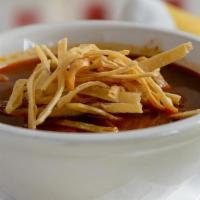 Sopa De Tortillas · Traditional tortilla soup with tomato & guajillo pepper broth, diced avocado, chihuahua chee...