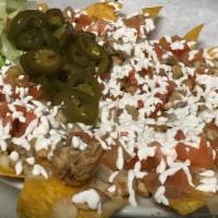 Nachos · Spicy. Tortilla chip topped with nacho cheese and jalapeños.