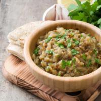 Fire Roasted Baba Ganoush · Roasted eggplant blended with tahini, olive oil, lemon and spices (served with warm pita bre...