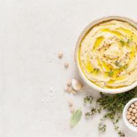 Lemon Garlic Hummus · Chickpeas blended with tahini, olive oil, lemon and spices (served with warm pita bread)