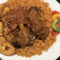 Curried Goat With Rice & Plantain · Curried goat served with plantains and your choice of rice.