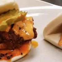 Sesame Hot Chicken Bao  · Kimchi-brined fried chicken coated in a sesame spice blend, spicy soy mayo and pickle.
