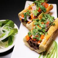 Sandwiches - Banh Mi · Yummy vietnamese bun-mee served with salad. Baguette filled with your choice of charbroiled ...