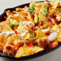 Chicken Nachos · Crispy corn tortilla chips covered with chicken, refried beans, cheese, jalapeños, pico de g...