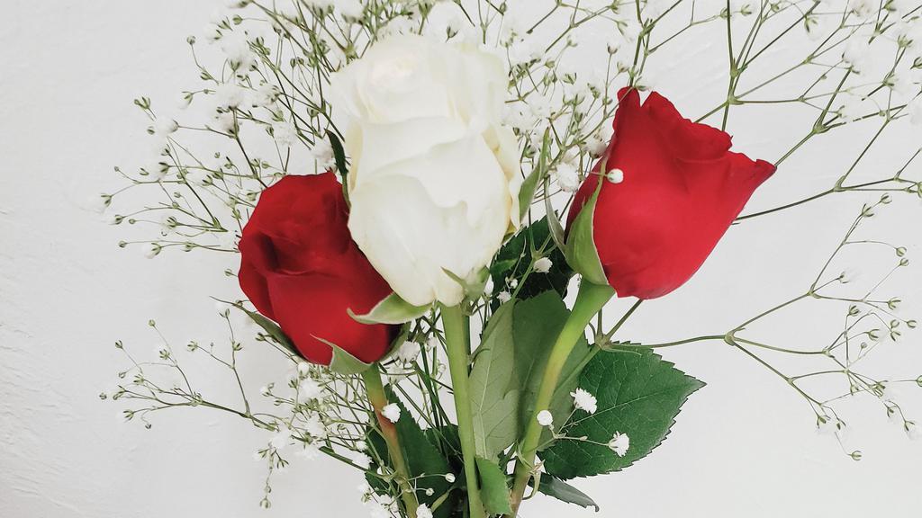 Red And White Long Stem Roses In Vase. (3 Stems) · 3 long stem roses in vase. 2 red, and 1 white. Arranged in glass vase and arranged with baby's breath, and  bow around vase.