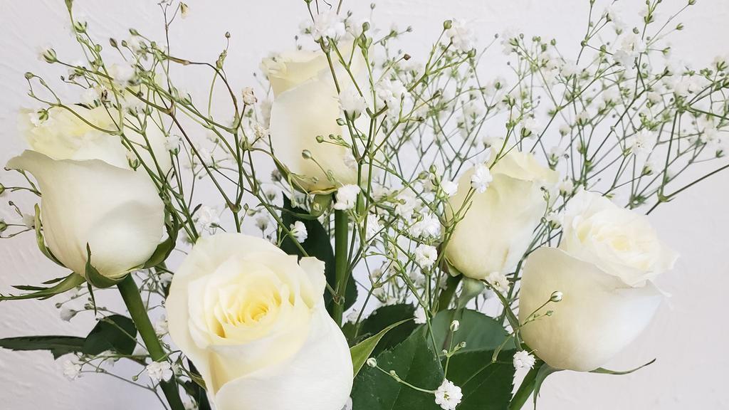Half Dozen White Long Stem Roses Arranged Beautifully In Glass Vase  · 6 stems of long stem white roses with baby's breath arranged in glass vase
