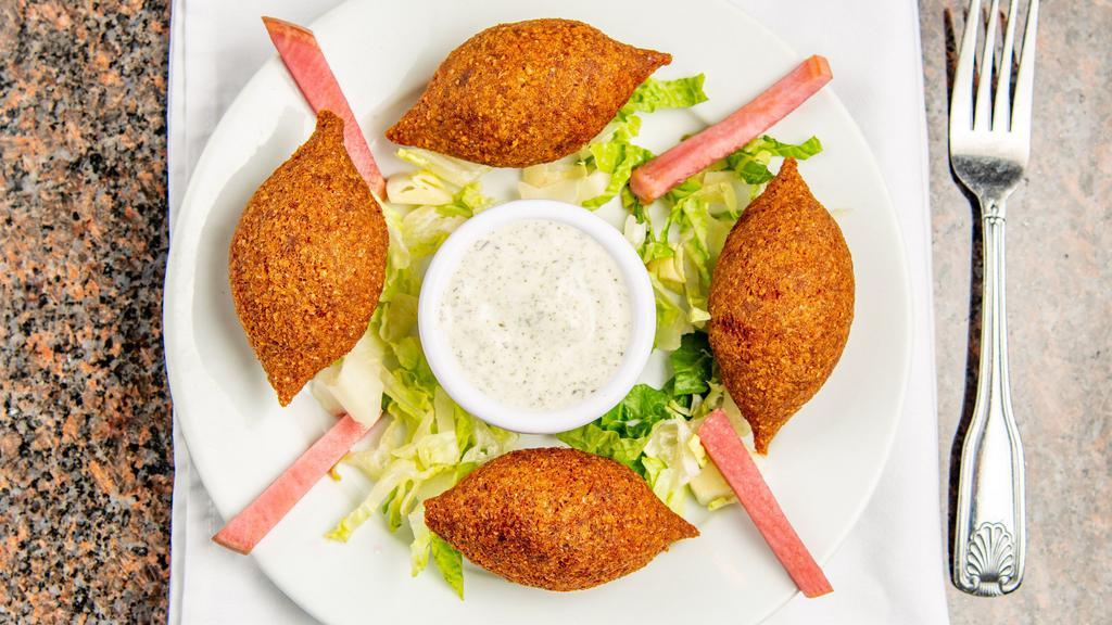 Fried Kibbeh · Deep fried Angus ground beef and cracked wheat shells, stuffed with a mix of Angus ground beef, diced onions and pine nuts. Served with yogurt.