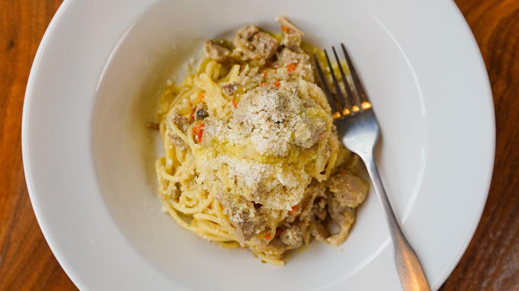 Duck Ragù · Rich and fragrant. The duck is first roasted then braised in its own reduction with a hint of fennel pollen. Topped with Parmigiano Reggiano cheese.