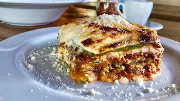 Lasagna Alla Bolognese · Traditional bolognese sauce and homemade bechamel layered in egg dough pasta, baked in the oven.