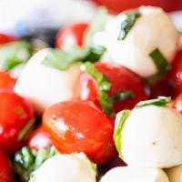 Caprese Salad · Fresh Mozzarella, Tomatoes, Basil, Seasoned with Salt, Black Pepper, Fresh Garlic & Olive Oil