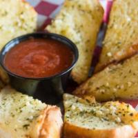Garlic Bread · Sliced Garlicky Bread Served With Our In-house Marinara Sauce