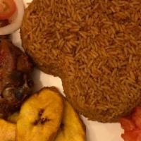 Jollof Rice · Par Boiled Rice cooked in red bell peppers, onion, tomato and Jollof rice seasoning. Its com...