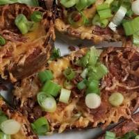 Potato Skins · Traditional Potato Skins topped with Cheddar Cheese, Bacon and Chives.  Served with Salsa an...