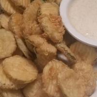 Fried Pickles · Sliced Dill Pickle Slices, Lightly Fried and served with Creek Sauce.