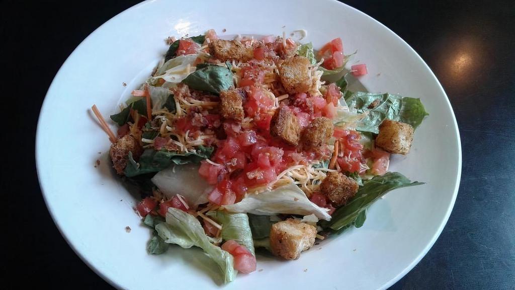 House Salad · Fresh Greens topped with Cheddar Cheese, Tomatoes, Bacon and Croutons.