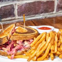 Reuben Grill · Thin slices of lean corned beef grilled with sauerkraut, topped with swiss cheese and 1000 I...