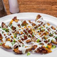 Potato Skins · Topped with bacon, scallions and drizzled with ranch.