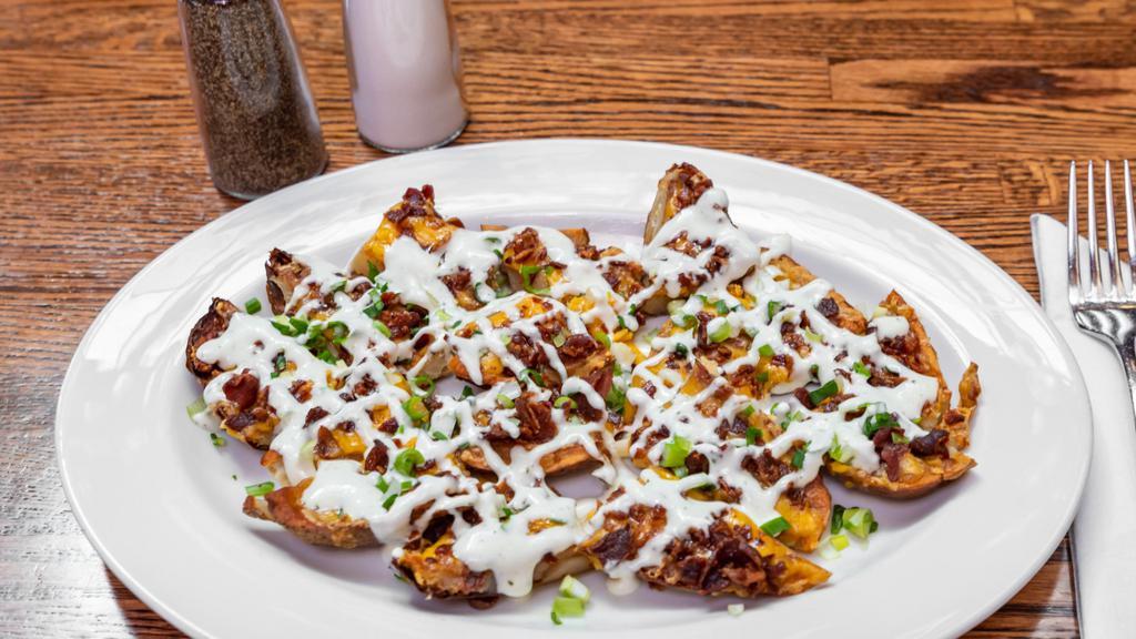 Potato Skins · Topped with bacon, scallions and drizzled with ranch.