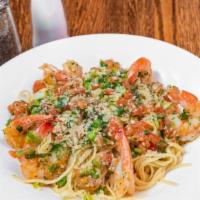 Shrimp Scampi · Shrimp, tomatoes, scallions, garlic in a lemon butter white wine sauce over linguini. Served...