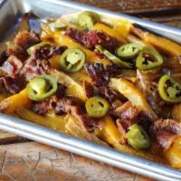 Treat-Yo-Self · Our cheese fries topped with bacon pieces & jalapenos served with a peppercorn ranch