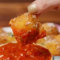 Fried Cheese Ravioli · breaded deep-fried cheese ravioli served with tomato sauce.