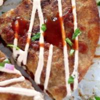 Chicken Tinga Quesadilla · Shredded chicken cooked with tomato, onions and chipotle sauce and cheese inside a buttered ...