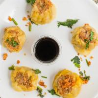 Thai Dumpling · Steamed dumplings stuffed with shrimp and chicken, served with special soy sauce.