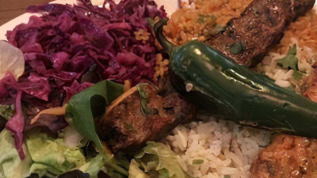 2 Skewers Adana Kobab Over Rice  · 2 skewers of Adana Kobab over rice with cabbage